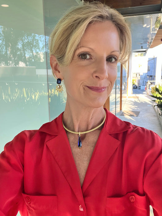 Woman wearing a red shirt with a blurred outdoor background