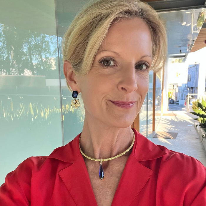 Woman wearing a red shirt with a blurred outdoor background