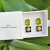 Green earrings in a white box with 'The Christy F Collection' logo on a green leafy background