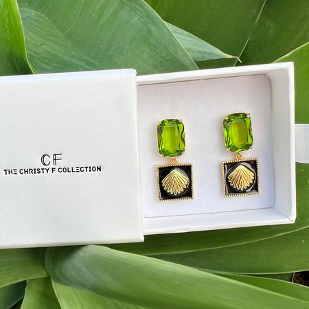Green earrings in a white box with 'The Christy F Collection' logo on a green leafy background