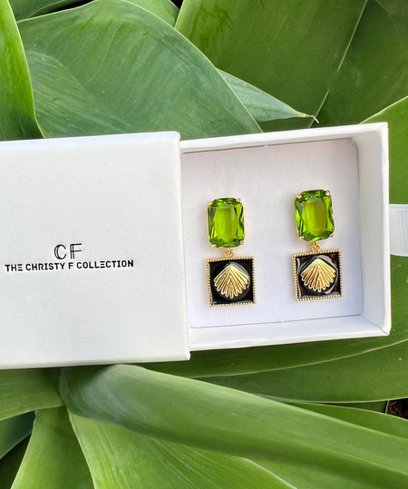 Green earrings in a white box with 'The Christy F Collection' logo on a green leafy background