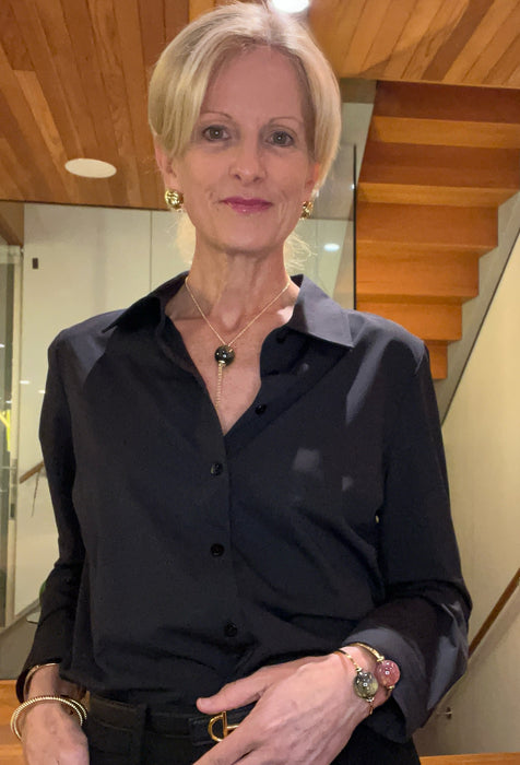 Woman wearing a black shirt with a blurred background