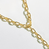 A gold-filled cable link chain necklace with a lariat style drop, featuring a bold and luxurious design.