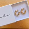 Gold hoop earrings in a white box with 'The Christy F Collection' branding.