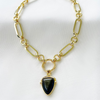 A black shield-shaped pendant on a gold-filled chain choker necklace.