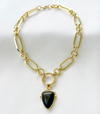 A black shield-shaped pendant on a gold-filled chain choker necklace.