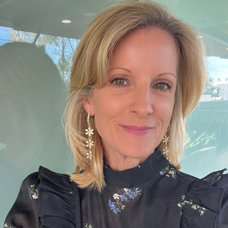 Woman wearing a black floral blouse indoors