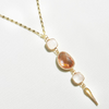 A gold-filled chain necklace with pastel gemstones and micro pave diamonds, featuring a lariat style pendant.
