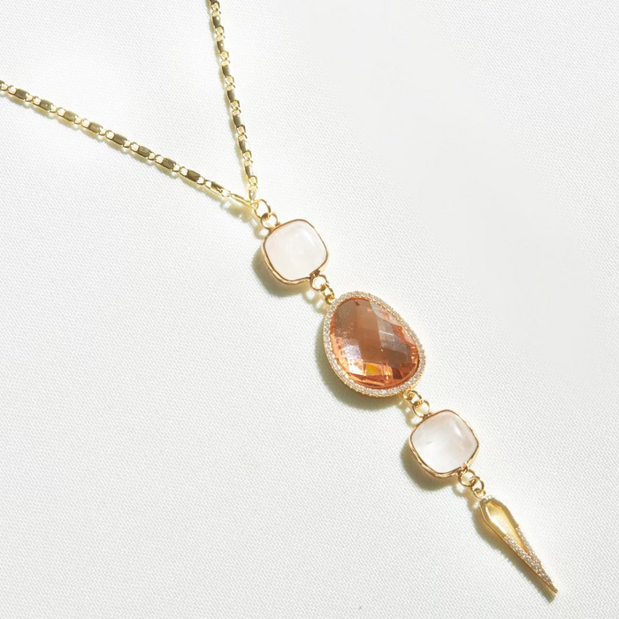 A gold-filled chain necklace with pastel gemstones and micro pave diamonds, featuring a lariat style pendant.