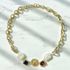 Gold chain necklace with decorative elements on a marble surface