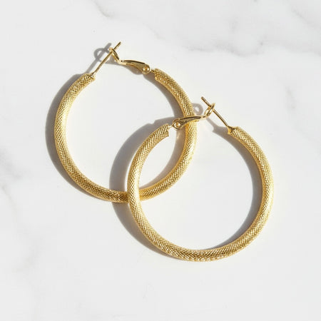 Gold hoop earrings on a white background