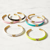 Set of colorful bangles with gold accents on a white background