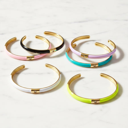 Set of colorful bangles with gold accents on a white background
