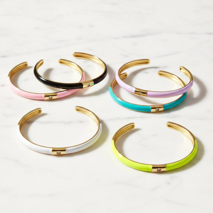 Set of colorful bangles with gold accents on a white background