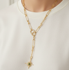 Gold chain necklace with a star pendant worn by a person on a white background