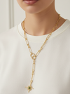Gold chain necklace with a star pendant worn by a person on a white background