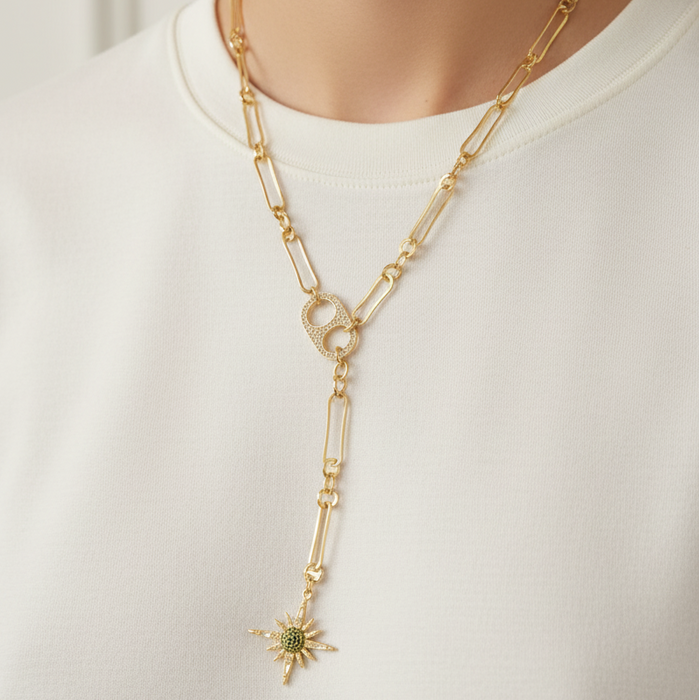 Gold chain necklace with a star pendant worn by a person on a white background