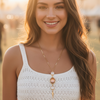 Woman wearing a white crochet top with a blurred background