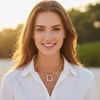 Woman wearing a gold necklace with a blurred natural background