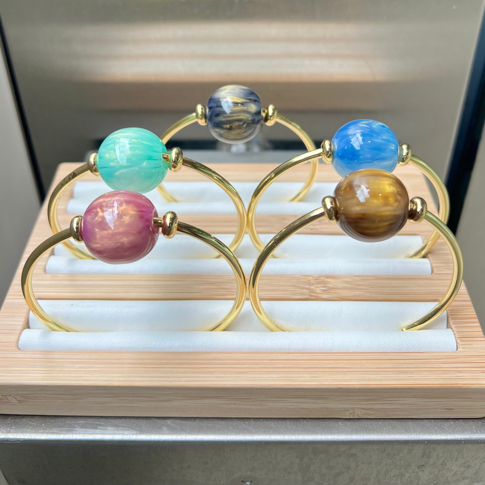 Jewelry display with colorful glass bead bracelet on a wooden stand