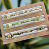 Wooden jewelry box with rings on a blurred green background