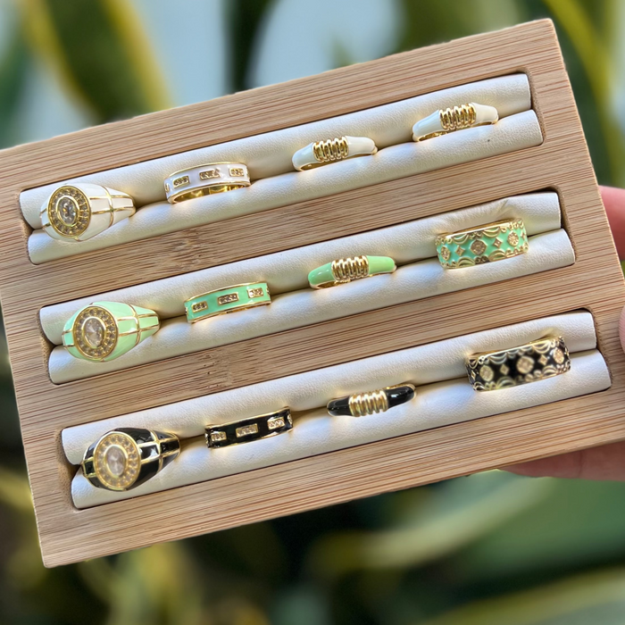 Wooden jewelry box with rings on a blurred green background