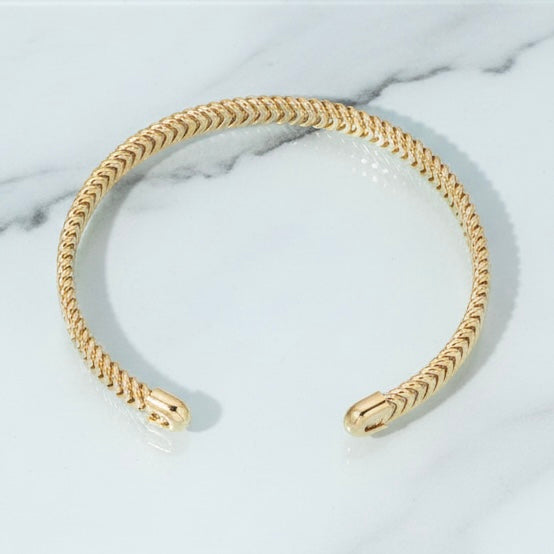 Gold chain headband on a marble surface