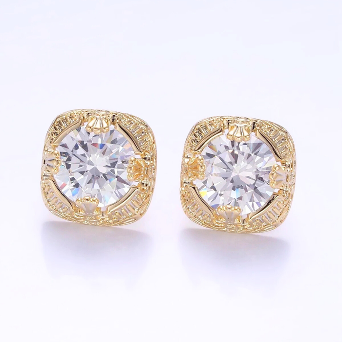 Gold earrings with clear gemstones on a white background