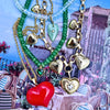 Necklace with heart-shaped charms on a scenic background