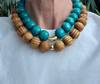 Necklace with turquoise and wooden beads on a white surface