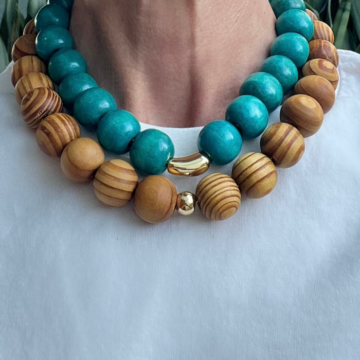 Necklace with turquoise and wooden beads on a white surface