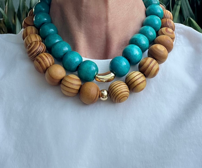 Necklace with turquoise and wooden beads on a white surface