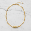 Gold chain necklace on a marble surface