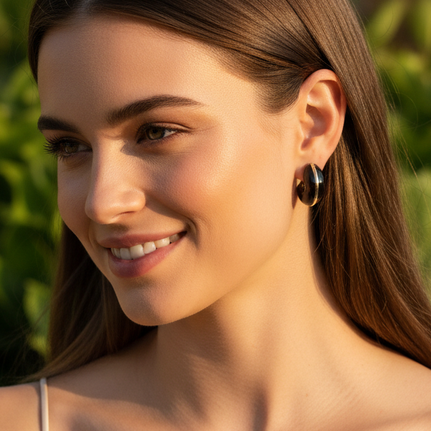 Woman wearing a white tank top with green foliage in the background