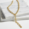 Gold chain necklace on a marble surface