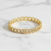 Gold bracelet with diamond accents on a marble surface