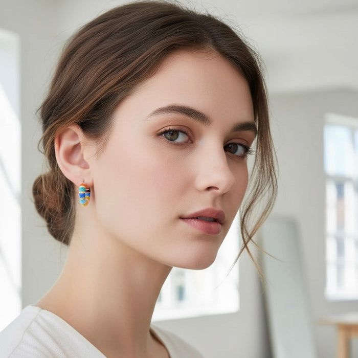 Woman wearing colorful earrings in a bright room