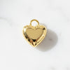 Gold heart-shaped pendant on a white background