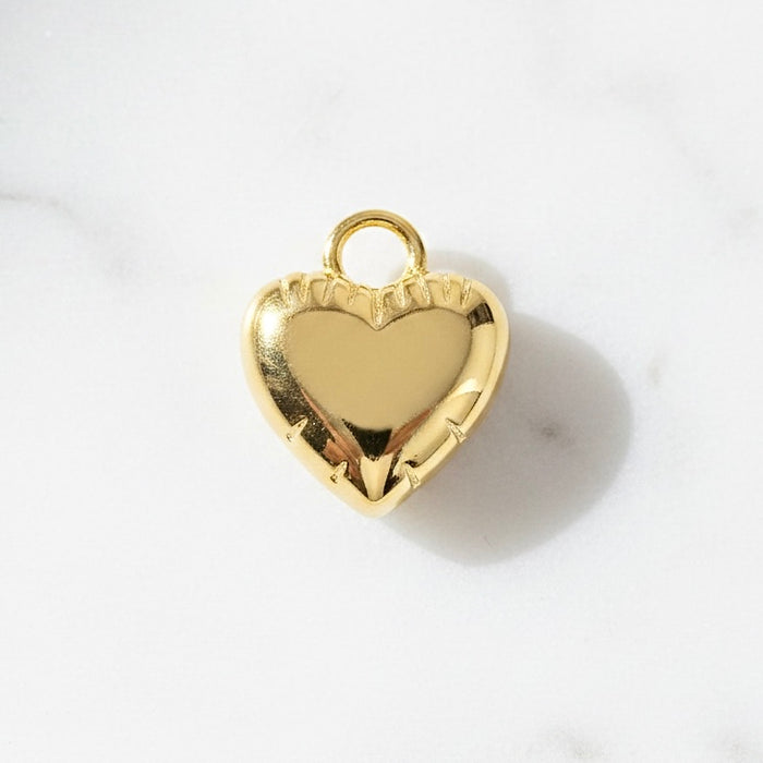 Gold heart-shaped pendant on a white background