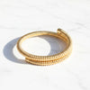 Gold bracelet on a white background