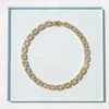Gold diamond necklace with clear stones on a white background