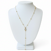Gold beaded necklace on a white mannequin bust