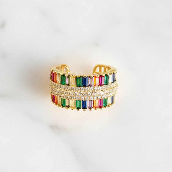 Multicolored beaded ring with gold accents on a white background