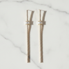 Pair of gold chain earrings on a marble surface