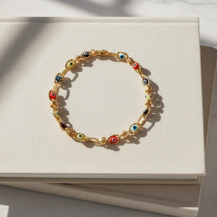 Multicolored beaded bracelet on a white card with a marble background