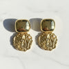 Pair of gold earrings on a white background