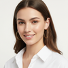 Woman wearing gold hoop earrings on a white background