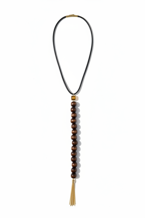 Wanderlust Lariat flat lay showing tiger's eye connector, wooden beads and gold chain tassel