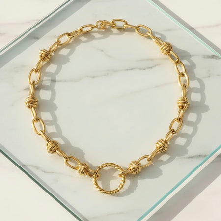 Gold chain necklace on a marble surface