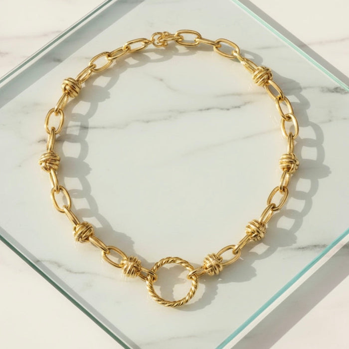 Gold chain necklace on a marble surface